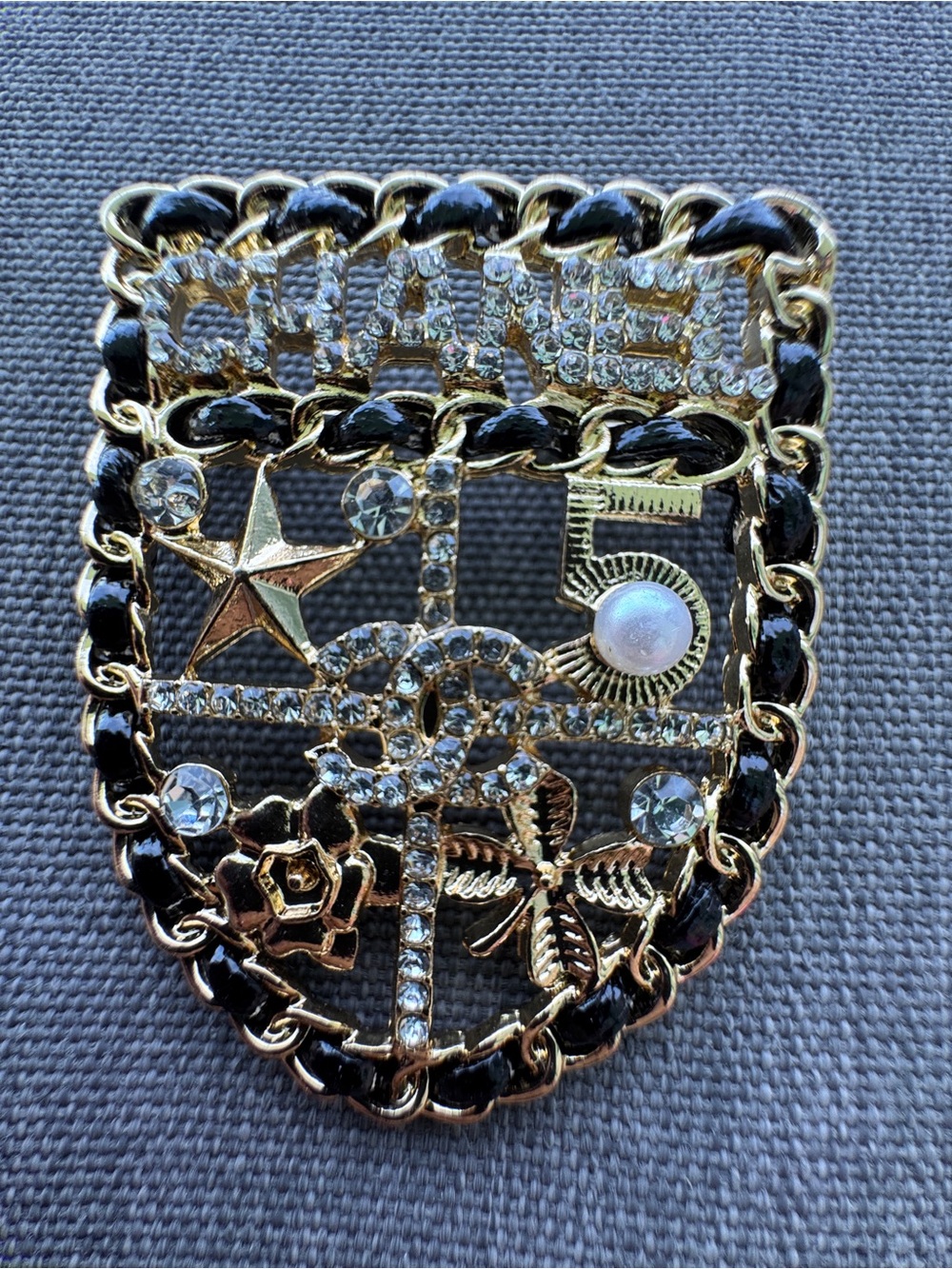 Luxury Gold-Tone Shield Brooch with Black Enamel & Clear Rhinestones